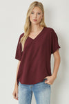 Solid v-neck top featuring asymmetric rounded hem detail. Unlined - 3 Colors