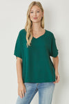 Solid v-neck top featuring asymmetric rounded hem detail. Unlined - 3 Colors
