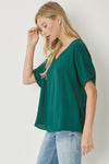 Solid v-neck top featuring asymmetric rounded hem detail. Unlined - 3 Colors