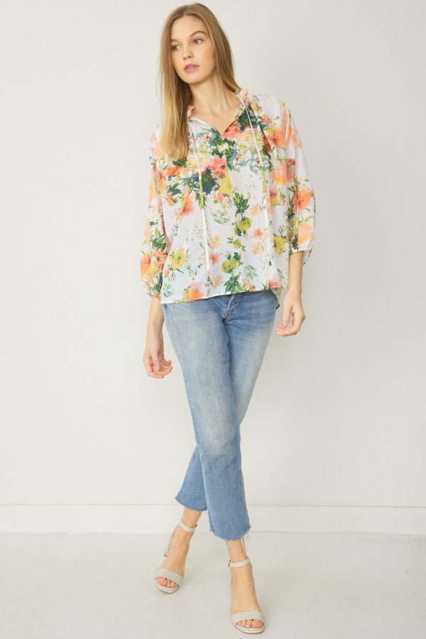 Floral Print v-neck long sleeve top featuring self tie detail at front.