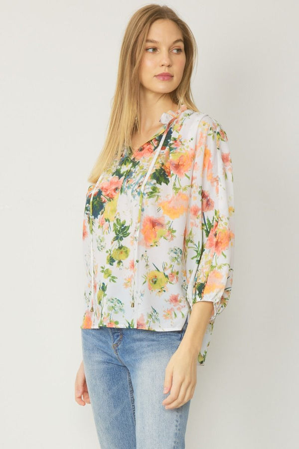 Floral Print v-neck long sleeve top featuring self tie detail at front.